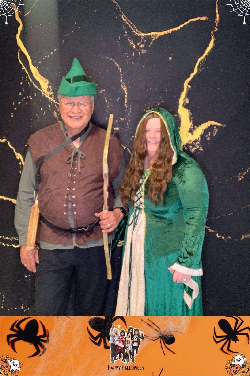 Returning Arnold, Maryland Halloween hosts in costume at Knightrin open-air Digital Delight photo booth with black and gold backdrop Returning Arnold, Maryland Halloween hosts in costume at Knightrin open-air Digital Delight photo booth with black and gold backdrop