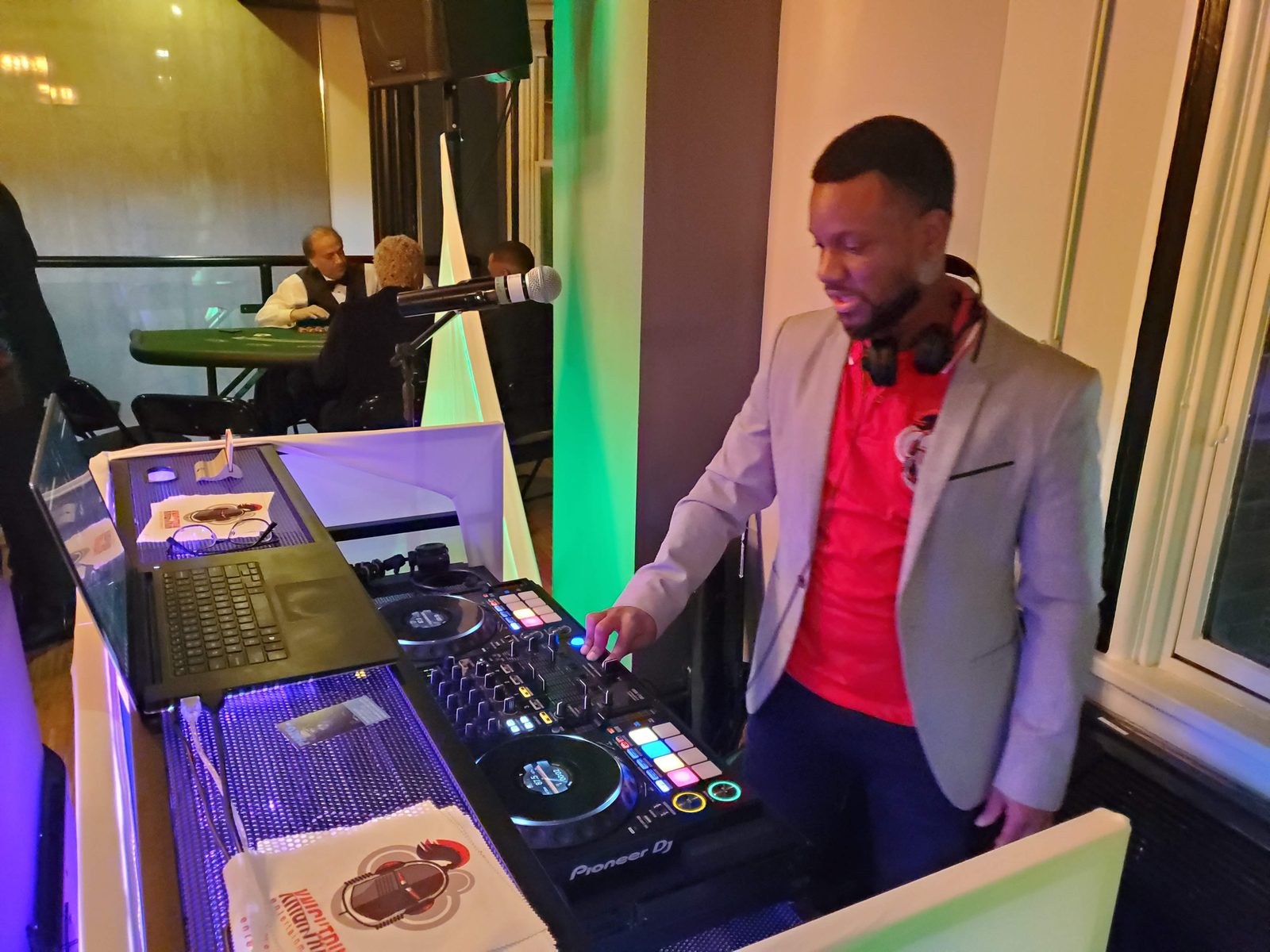 Corporate holiday party DJ Knightrin mixing at the controller during a company celebration in the DMV